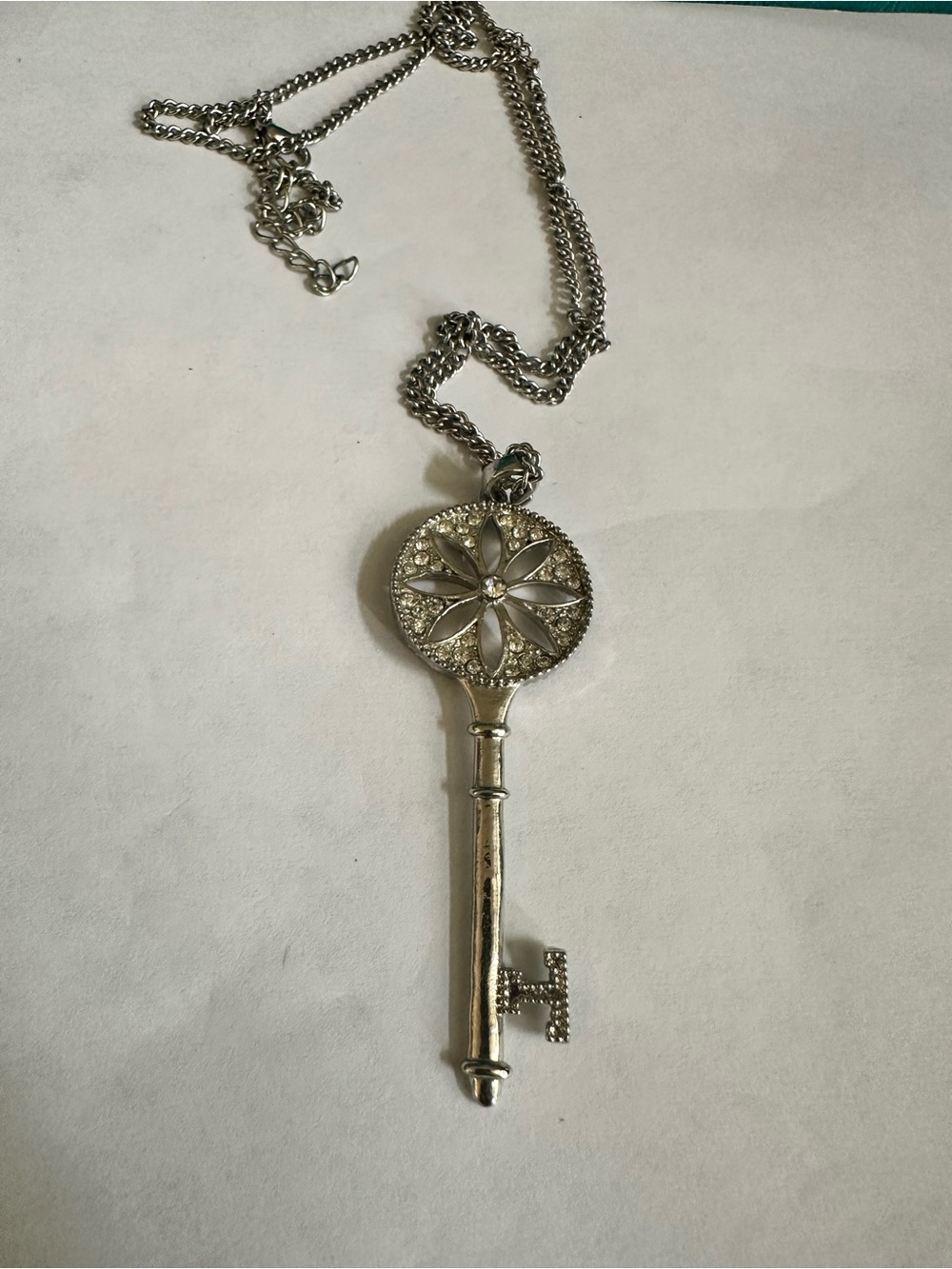 Silver Key Pendant Necklace with Floral Medallion